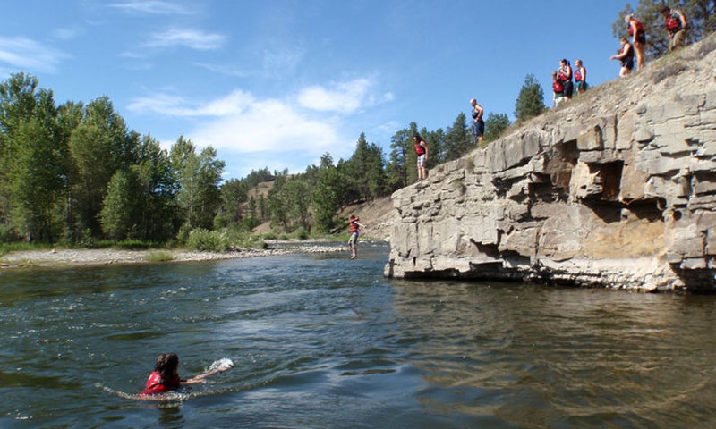 Jumping from a rock during a Whitewater Rafting Adventure